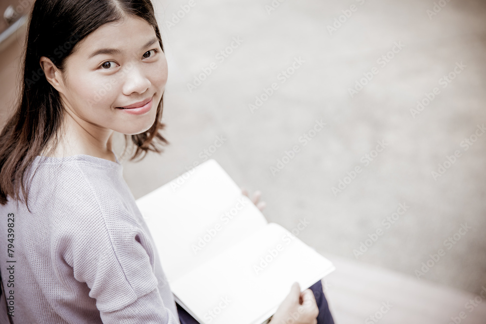 attractive female college student sitting on stairs attractive female college student sitting on stairs