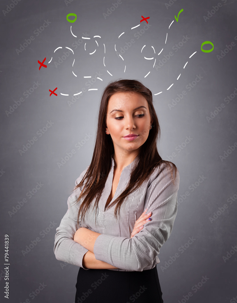 Young woman thinking with abstract marks overhead Young woman thinking with abstract marks overhead