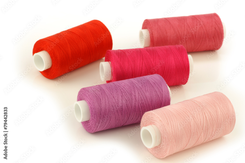 colorful spindles of yarn on a white background colorful spindles of yarn on a white background