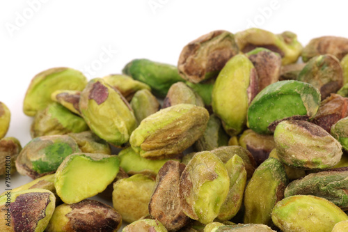 bunch of dried pistachio nuts on a white background
