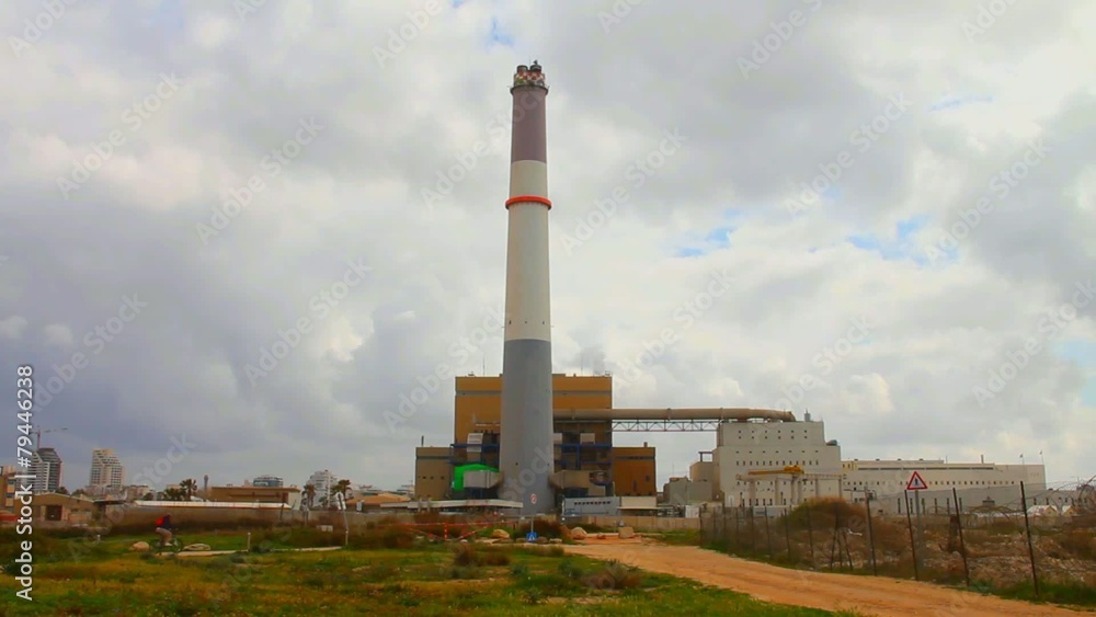 Stormy clouds time lapse on sky over small power plant Stormy clouds time lapse on sky over small power plant