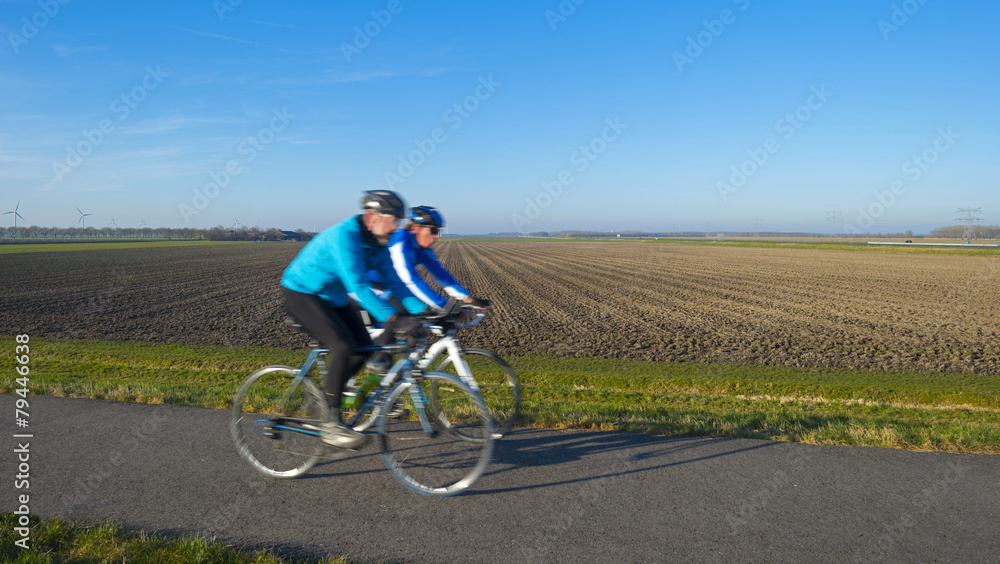 Cyclists on a countryside road in winter