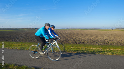Cyclists on a countryside road in winter