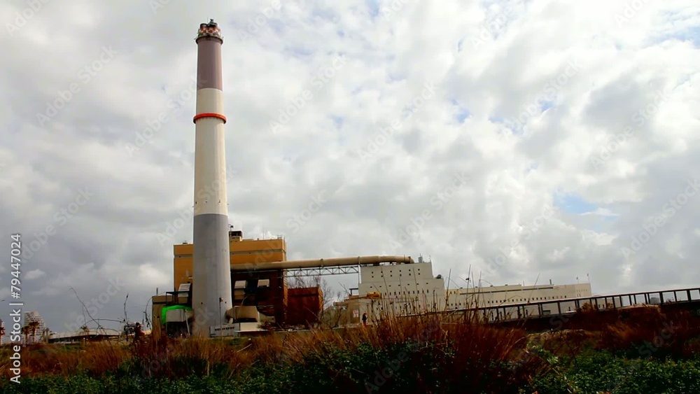 Stormy clouds time lapse on sky over small power plant Stormy clouds time lapse on sky over small power plant