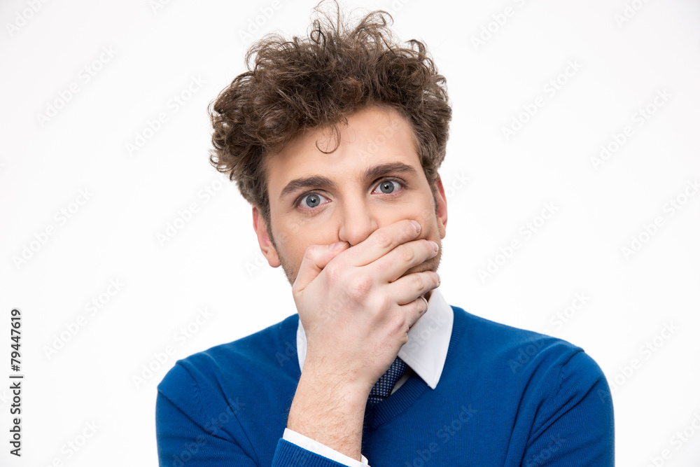 Handsome man covering his mouth over white background Handsome man covering his mouth over white background