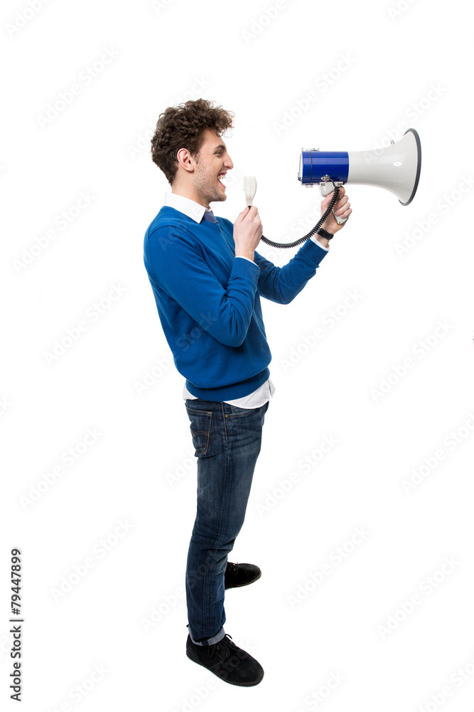Side view portrait of a man shouting through megaphone Side view portrait of a man shouting through megaphone