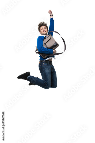 Smiling business man jumping with bag over white background