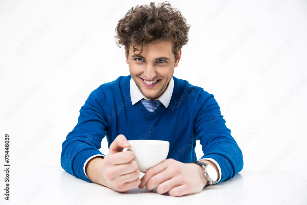 Cheerful business man sitting at the table with cup of coffee Cheerful business man sitting at the table with cup of coffee