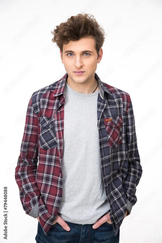 Young serious man standing over gray background Young serious man standing over gray background