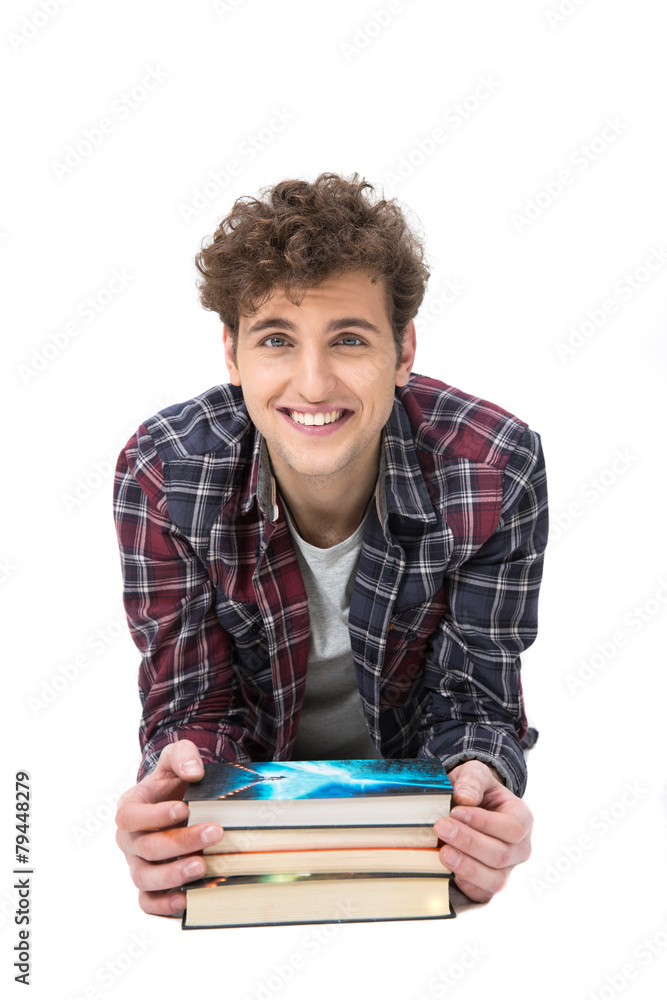 Happy young man leaning on the desk with books Happy young man leaning on the desk with books