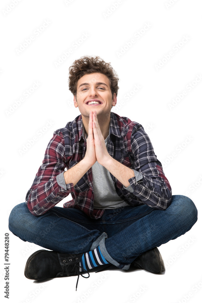 Happy young man with casual cloth sitting on the floor Happy young man with casual cloth sitting on the floor