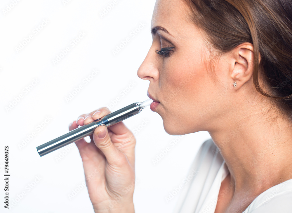 Fototapeta premium Young woman portrait with e-cigarette