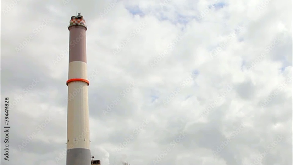 Chimney of power plant on dark stormy cloudy sky background Chimney of power plant on dark stormy cloudy sky background