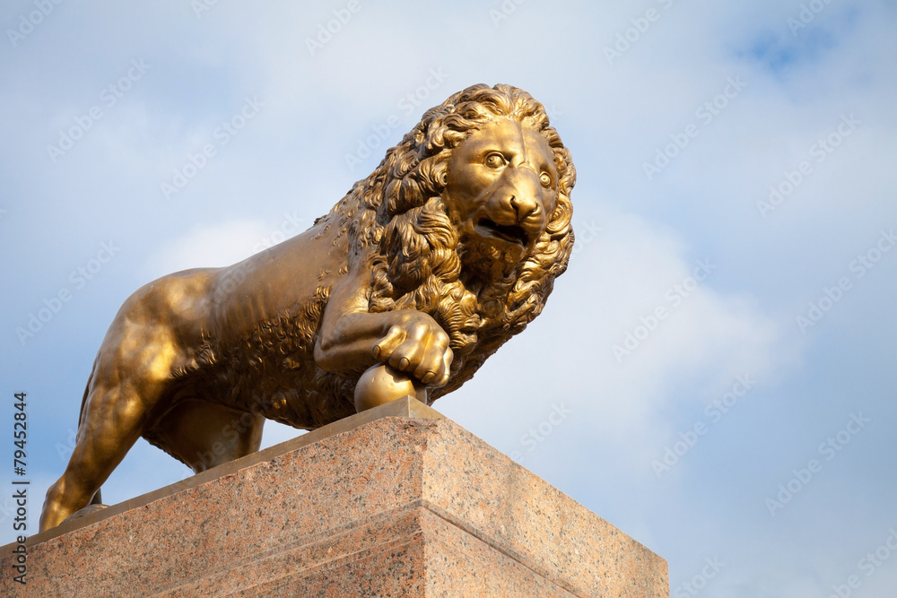 Bronze lion with ball, monument on stone base