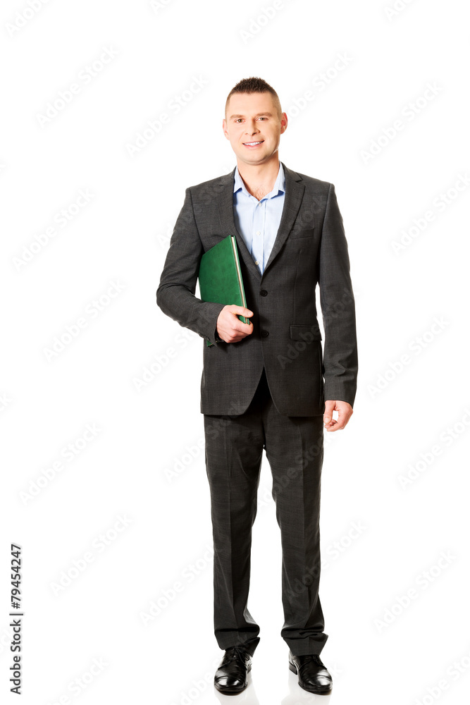 Young businessman holding his note book Young businessman holding his note book