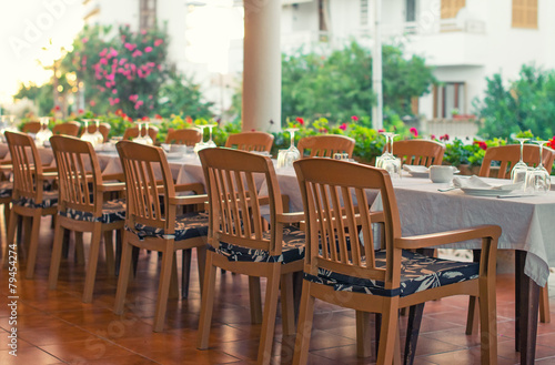 Setout table with tableware in modern restaurant.