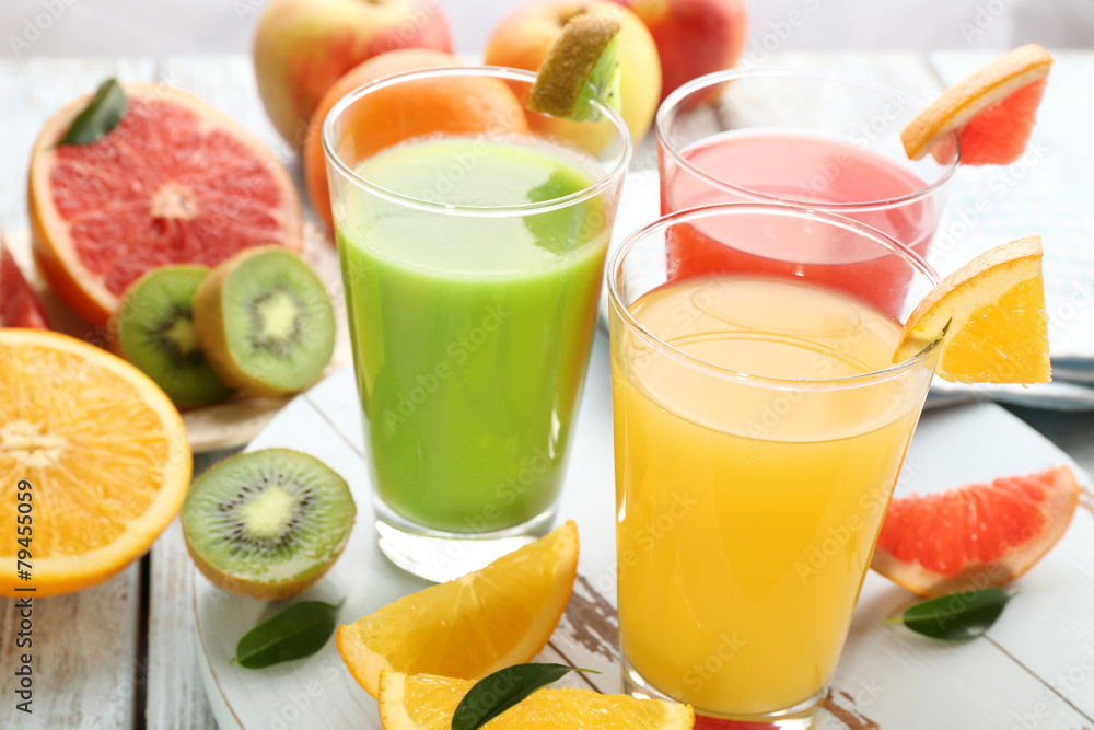 Fototapeta premium Fresh juices with fruits on wooden table