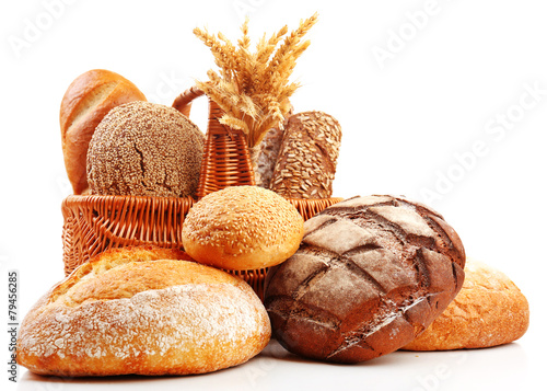 Fresh bread with wheat in wicker basket isolated on white