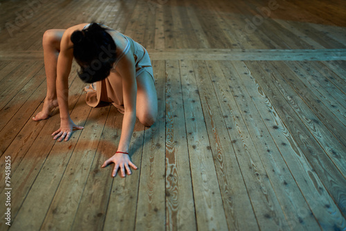 girl crawling on the floor in  ballroom photo