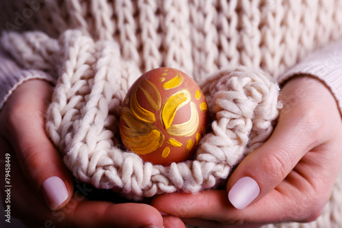 Woman holding Easter egg close up