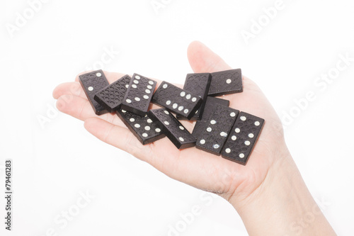 Dominoes in female hand on a white background