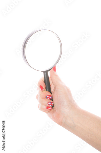 Female hand holding magnifying glass on a white background