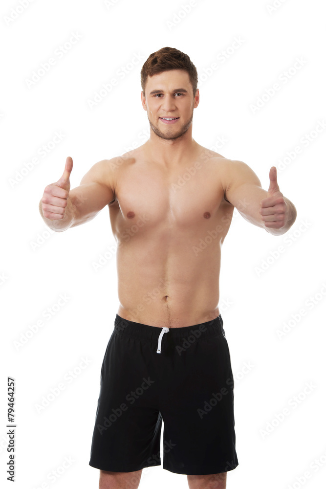 Sexy muscular man showing thumbs up. Sexy muscular man showing thumbs up.