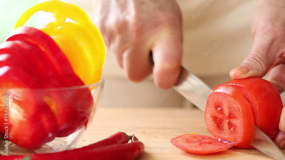 Close up panning shot of woman slicing lettuce on cutting board Close up panning shot of woman slicing lettuce on cutting board