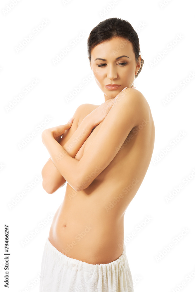 Portrait woman wrapped in towel with folded arms Portrait woman wrapped in towel with folded arms