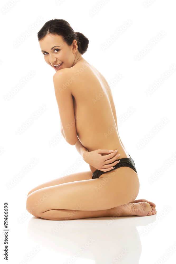 Topless woman sitting on knees Topless woman sitting on knees