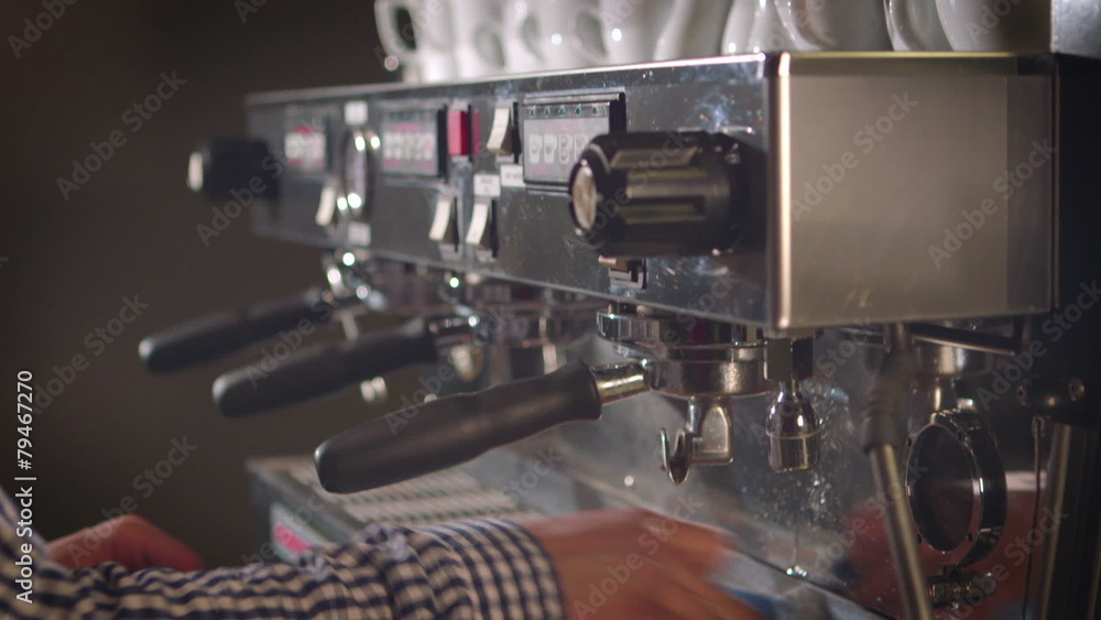 Preparing cups of espresso at a busy coffee shop Preparing cups of espresso at a busy coffee shop