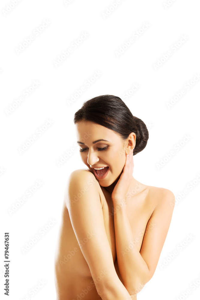 Topless woman sitting on desk, touching her neck Topless woman sitting on desk, touching her neck