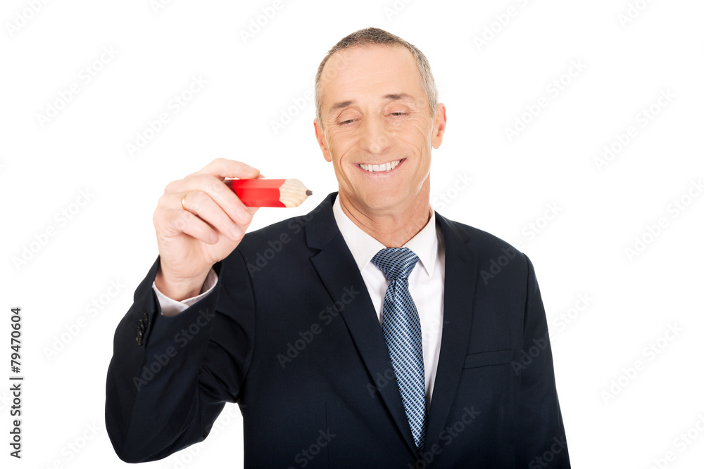 Manager writing with an oversized red pencil Manager writing with an oversized red pencil