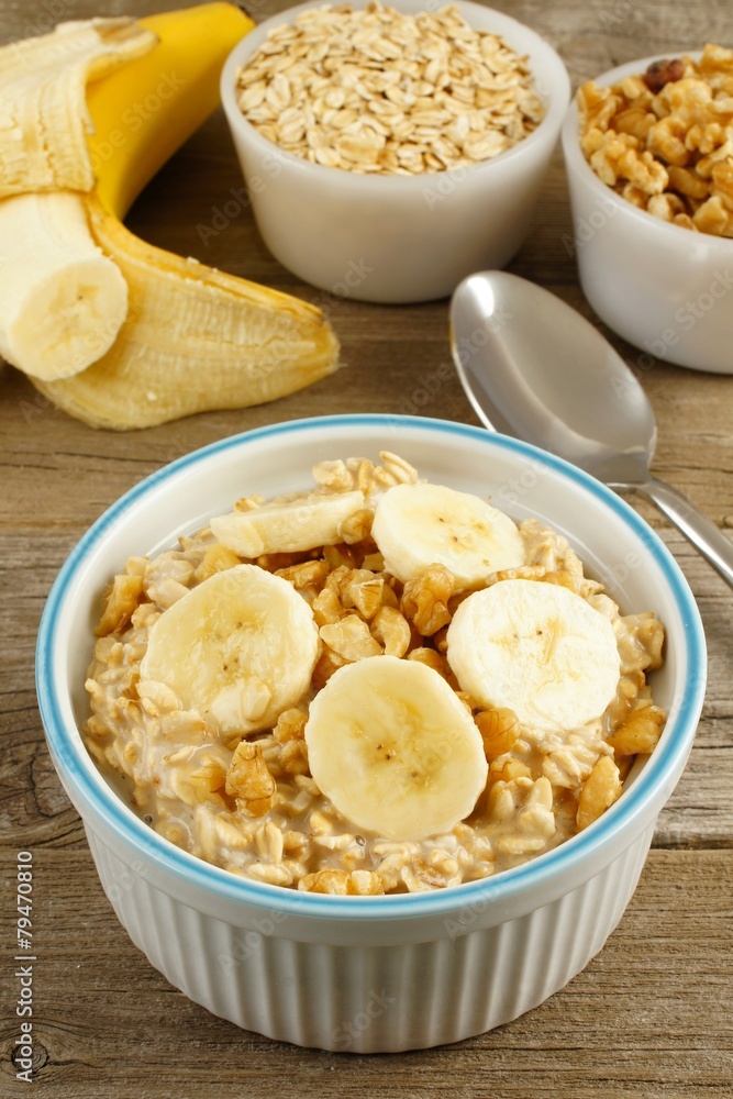 Banana walnut overnight oatmeal in a bowl on wood table Banana walnut overnight oatmeal in a bowl on wood table