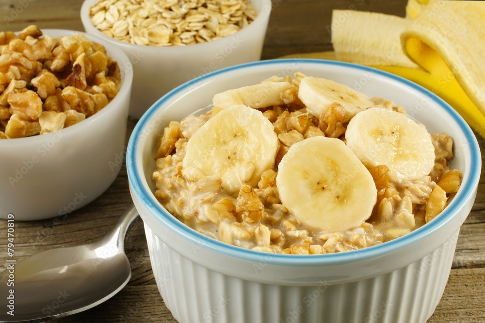 Banana walnut overnight oatmeal in a bowl on wood table Banana walnut overnight oatmeal in a bowl on wood table