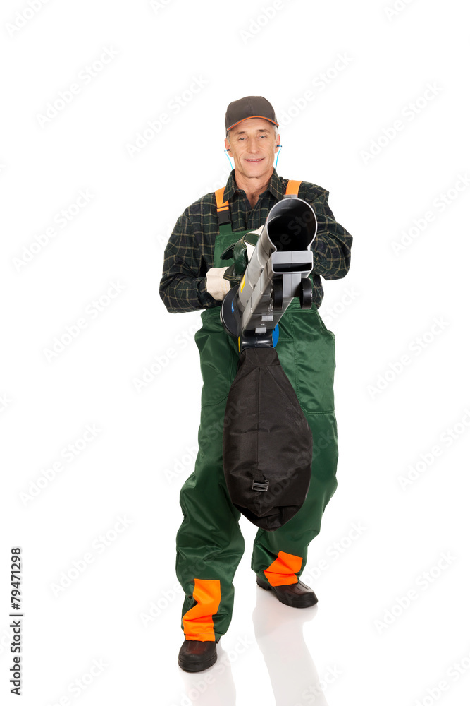 Worker in uniform with a leaf blower Worker in uniform with a leaf blower
