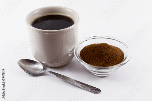 A cup of chicory and a small bowl of chicory powder