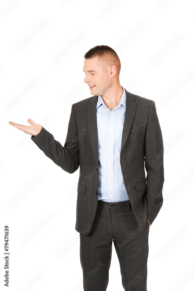 Smiling businessman holding copyspace Smiling businessman holding copyspace