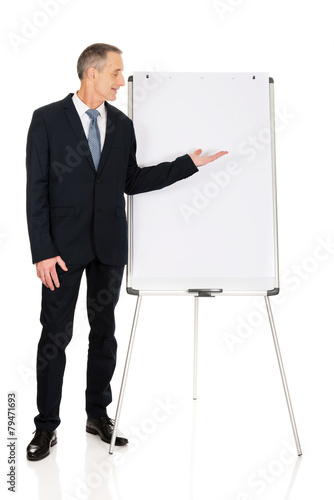 Male executive presenting on flip chart