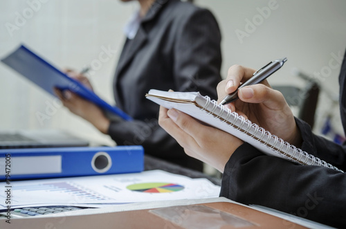 A row of hands writing