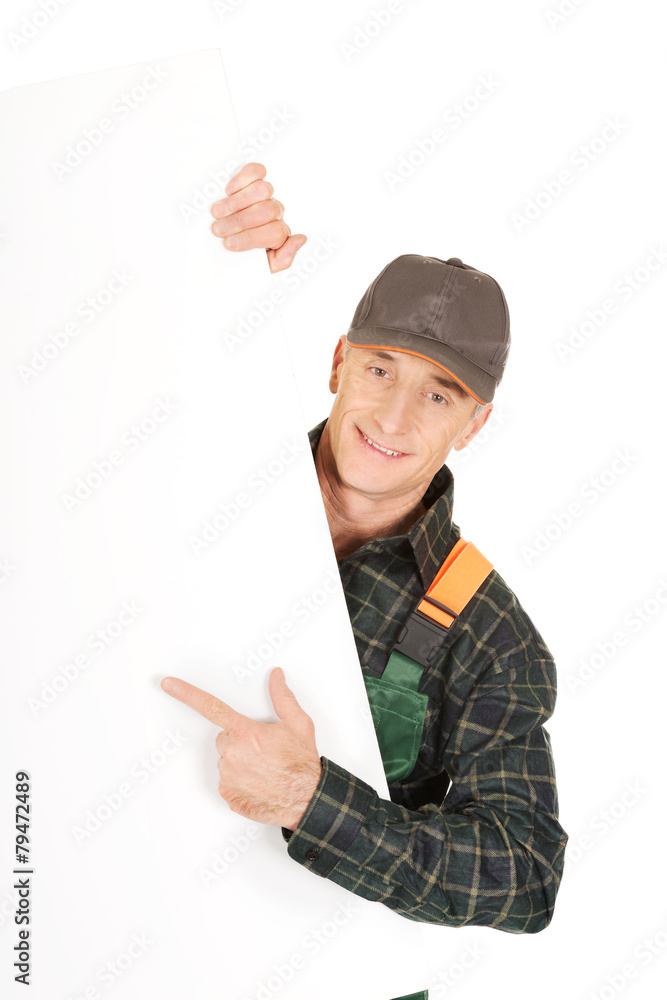 Gardener in uniform showing empty banner Gardener in uniform showing empty banner