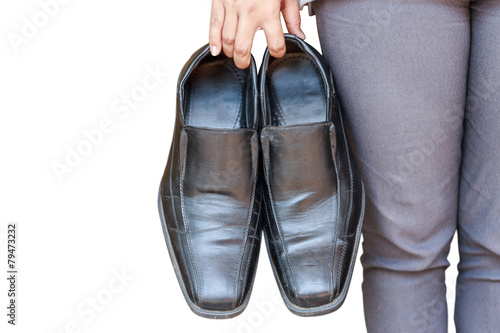Hand holding black shoe