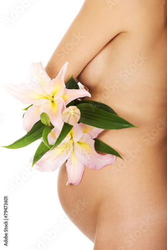 Fototapeta Naklejka Na Ścianę i Meble -  Pregnant woman holding a lily flower