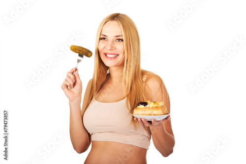 Happy pregnant woman with cake and pickles