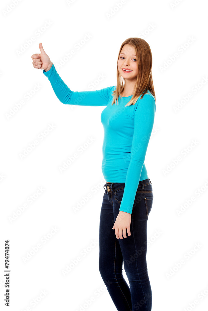 Happy female student showing thumbs up Happy female student showing thumbs up