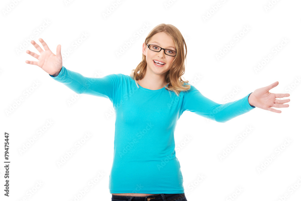Fototapeta premium Happy teenage woman with arms wide open