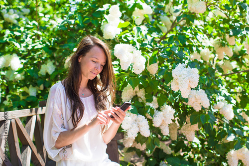 Young beautiful woman in the lush garden