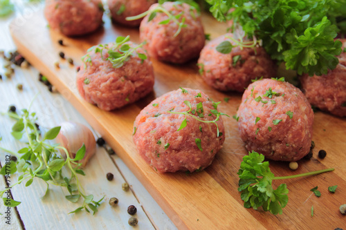 Raw meat balls with fresh parsley and herbs