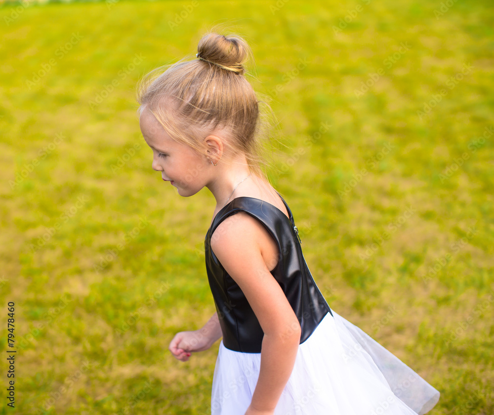 Obraz premium Adorable little girl happy outdoor at summer time