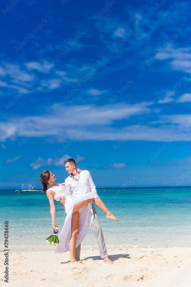 young loving couple on their wedding day, outdoor beach wedding young loving couple on their wedding day, outdoor beach wedding